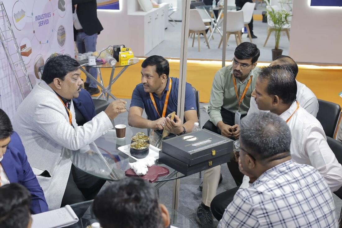 Buyers and exhibitors in discussion at a stand