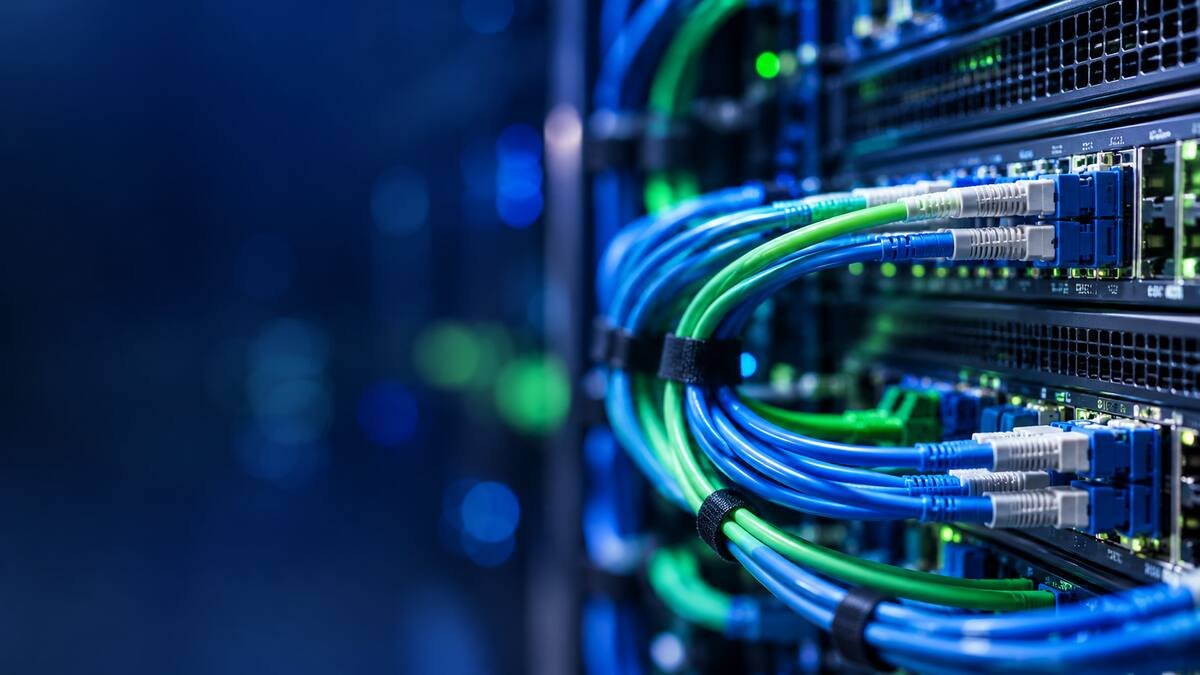 Blue and green fibre cables connected to a network switch